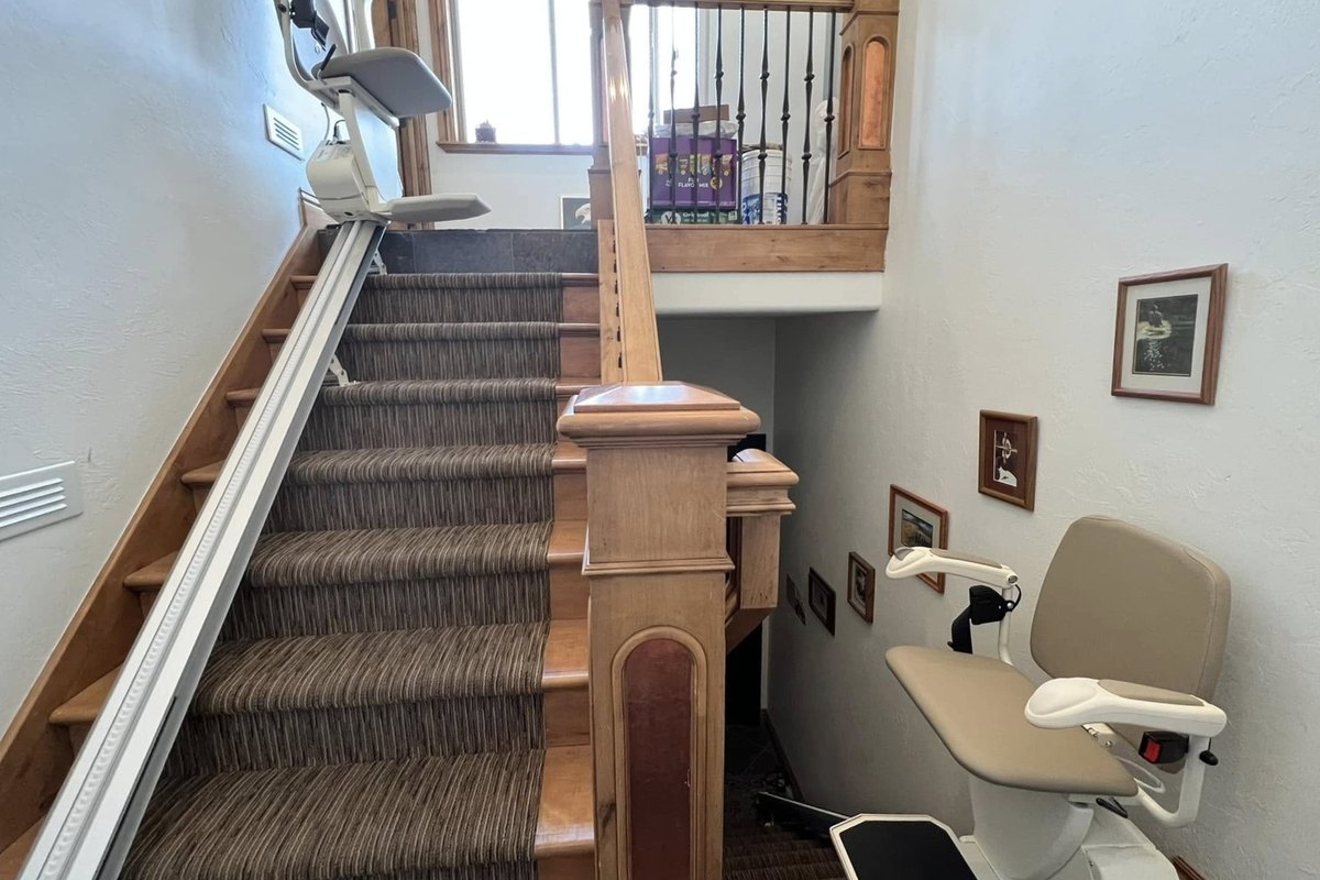 Split staircase with a stair lift installed on each flight
