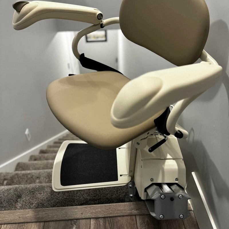 Harmar SL600 stair lift at the top of a carpeted staircase