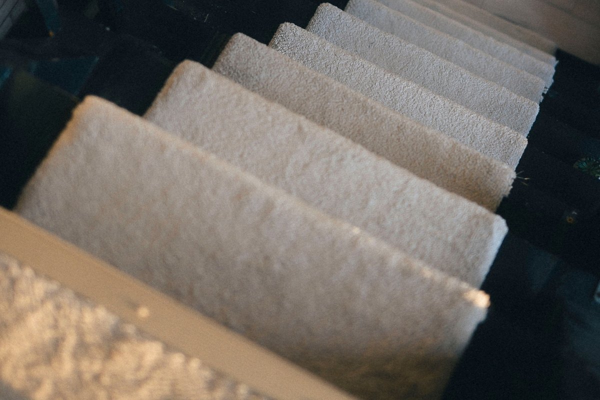 Looking down a flight of carpeted stair treads